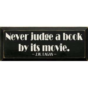  Never judge a book by its movie.   J.W. Eagan Wooden Sign 