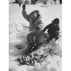  Eskimo Woman Showing Grandson How to Fish Through the Ice 