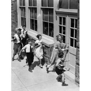  Seven Children Carrying Books, About To Enter Schoolhouse 