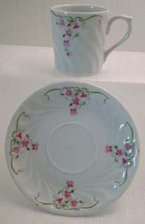 COLORS The set is bone china white with decoration in green, rose 