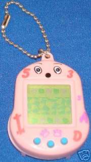 PINK DOGGY virtual pet electronic handheld keychain. Pet has been 