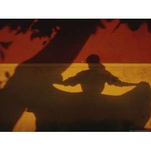 The Shadows of a Tree and Dancing Woman on a Brightly Painted Wall 